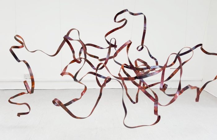 ‘Tangled’ by Saskia Singer is a suspended copper metal sculpture made in 2019.