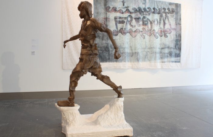 'Mohammad Plays', is a sculpture by Rachel Lowther, which depicts a child running.